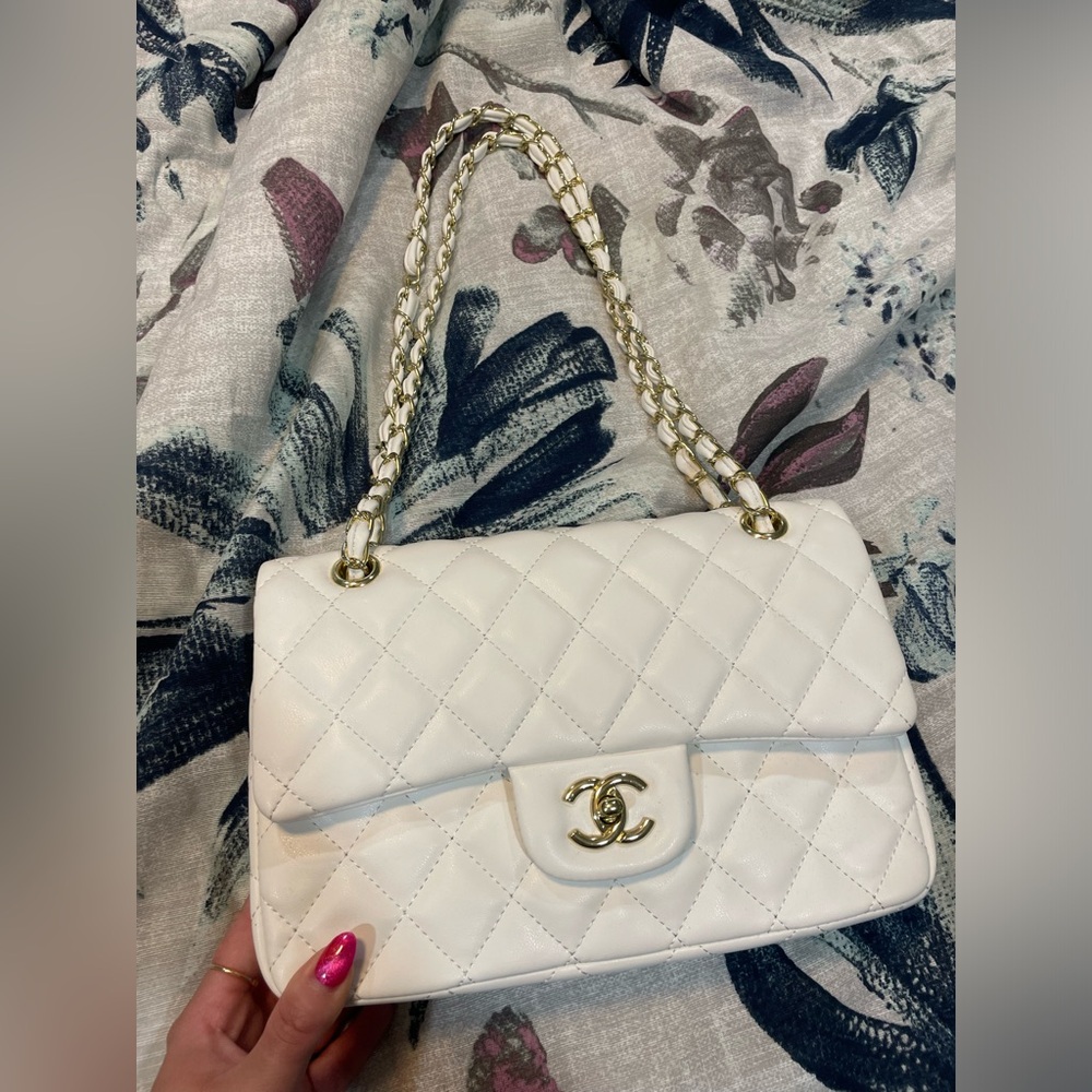 White quilted shoulder bag with gold accents